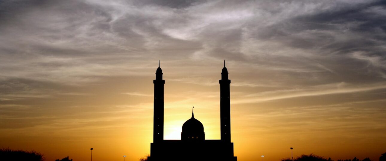 Silhouette of Mosque Below Cloudy Sky during Daytime