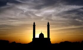 Silhouette of Mosque Below Cloudy Sky during Daytime