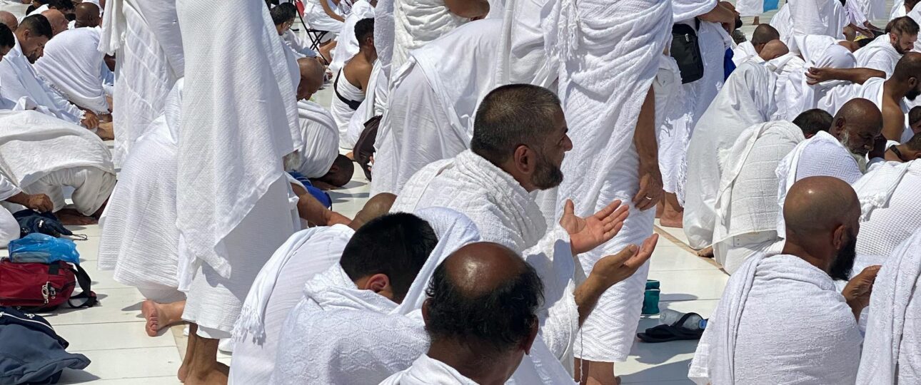 Believers Praying in the Courtyard in Ihram for umrah of the Great Mosque of Mecca