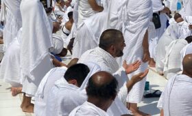 Believers Praying in the Courtyard in Ihram for umrah of the Great Mosque of Mecca